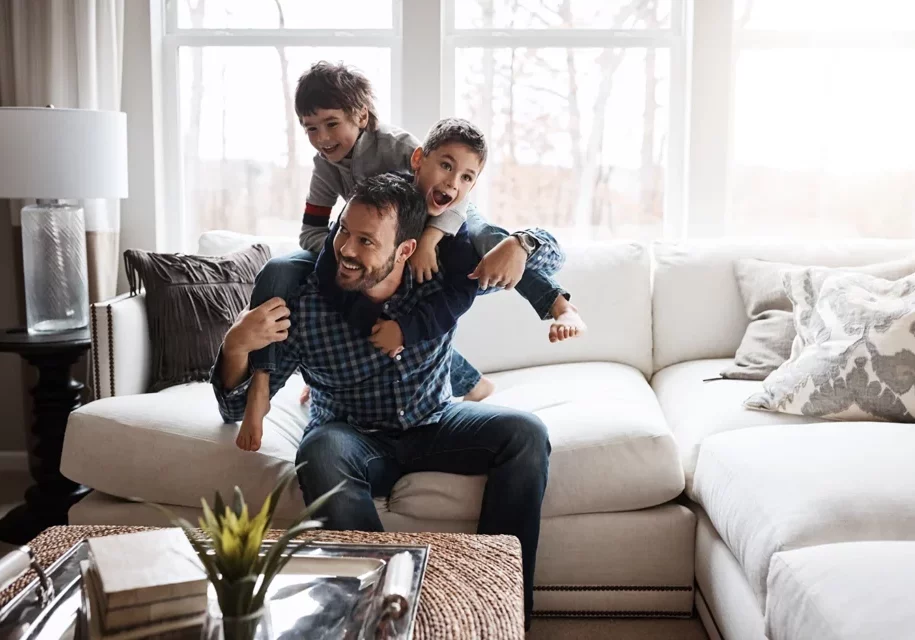 Family enjoying natural light from large living room windows in a Warsaw IL home