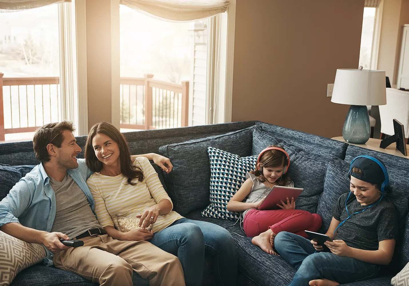 Versailles IL family enjoying comfortable living room with energy efficient replacement windows